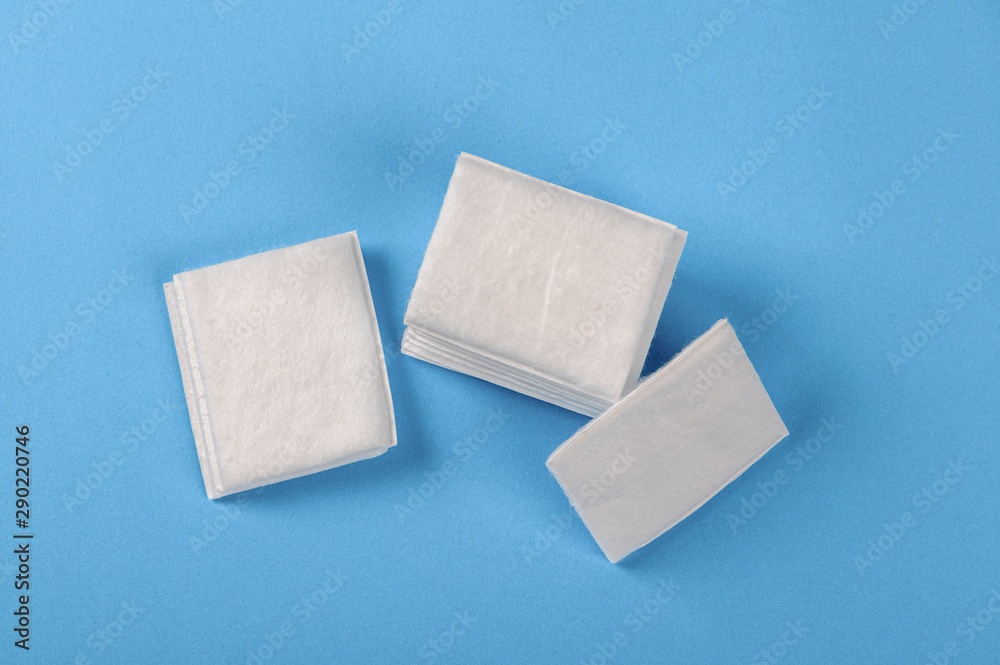 Cotton pads on blue background.top viewsanitaryrelaxation Cotton pads on blue background.top viewsanitaryrelaxation