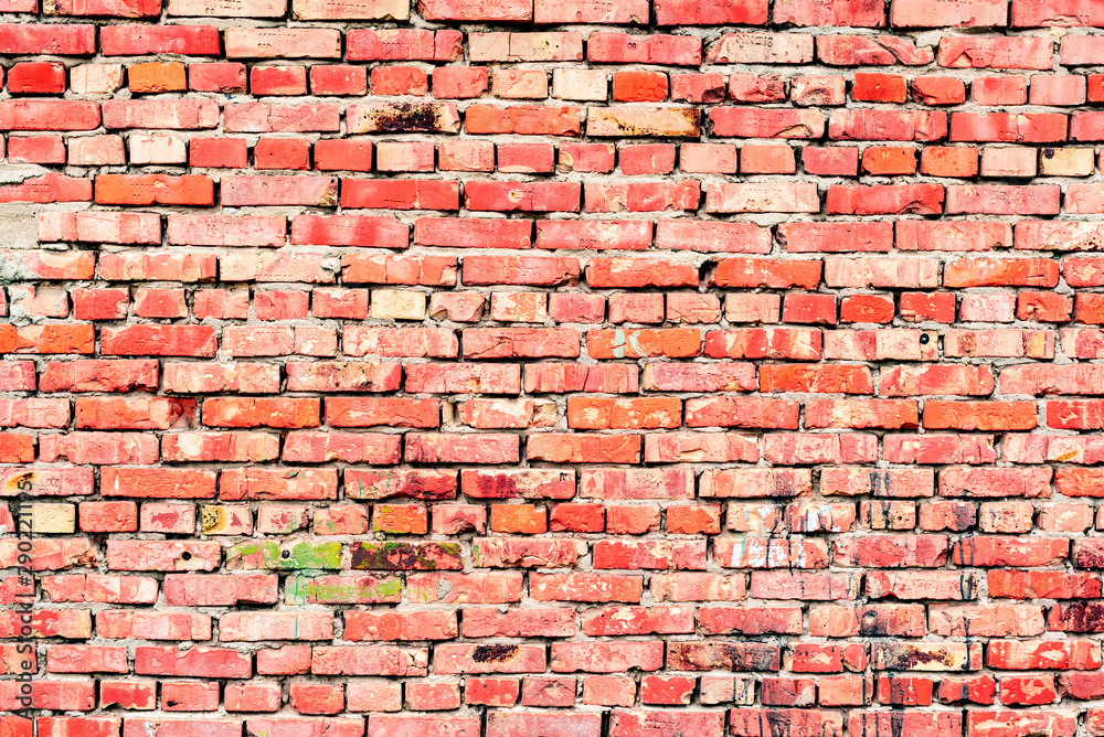 Obraz premium Texture of a brick wall with cracks and scratches which can be used as a background