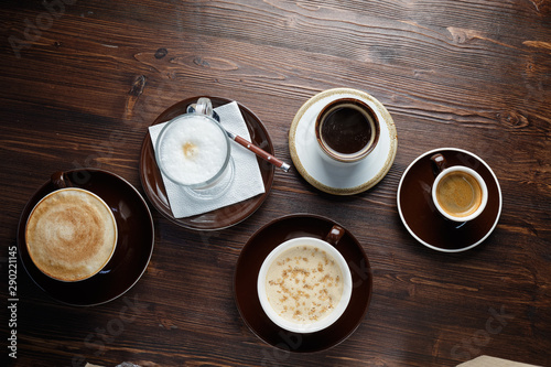 Cappuccino on a brown wooden background. Menu