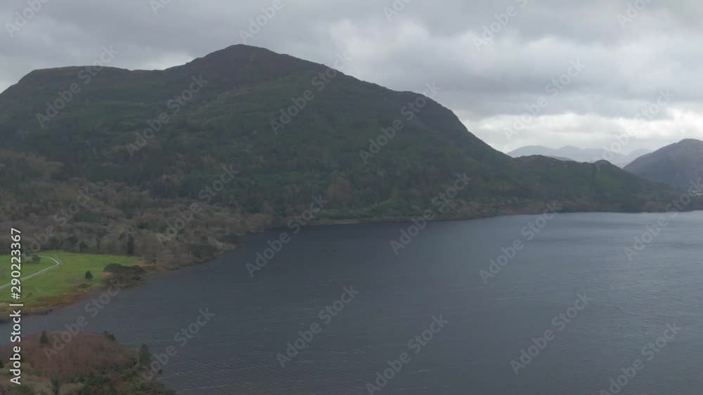 Drone flight over Muckross lake in Killarney national park towards mountain range during cold and cloudy summer day Drone flight over Muckross lake in Killarney national park towards mountain range during cold and cloudy summer day