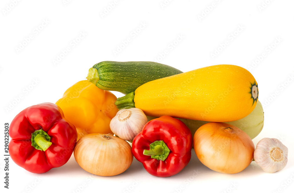 Vegetable set of bright ripe appetizing fruit peppers onion zucchini and garlic pink tomato and hot chili peppers on a white background