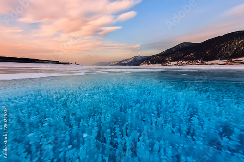 Bubbles of methane gas frozen into clear ice lake baikal, russia photo