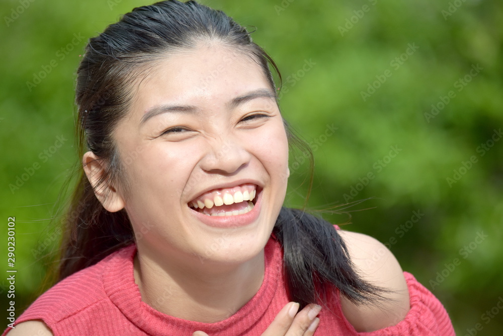 Fototapeta premium A Cute Filipina Female Youngster Laughing