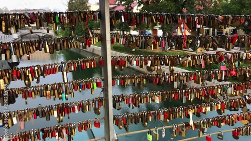 A lot of Locks hang on the bridge fence. photo