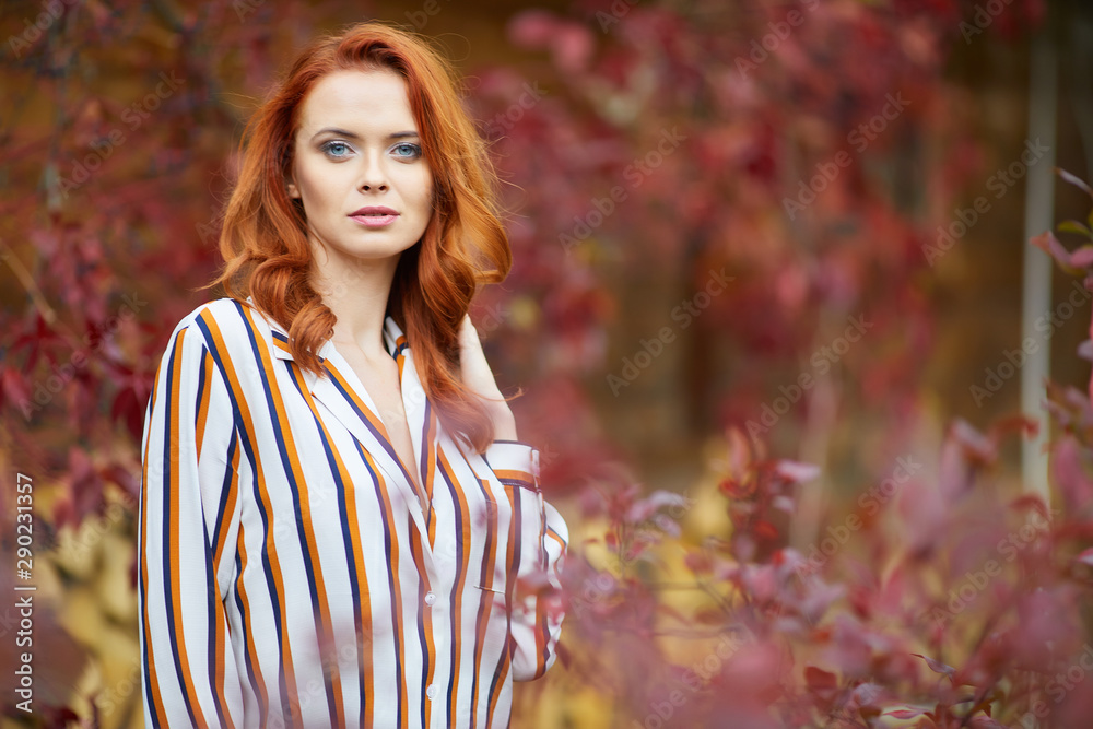 Smiling redhead outdoors backlit by sun, fashion shoot. Close up woman portrait . redhair girl. Beautiful young woman close-up in autumn . Smiling redhead outdoors backlit by sun, fashion shoot. Close up woman portrait . redhair girl. Beautiful young woman close-up in autumn .