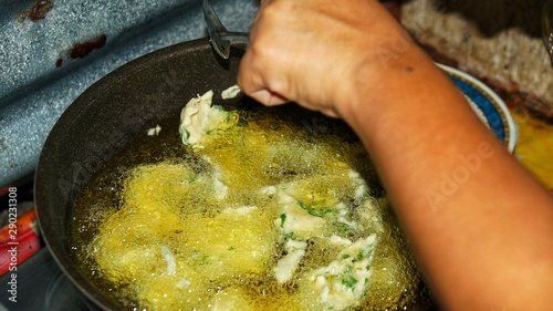 Cekodok frying in boiling oil. Popular traditional fritter snack also called jemput-jemput or cucur in Malaysia, Brunei and Indonesia. photo