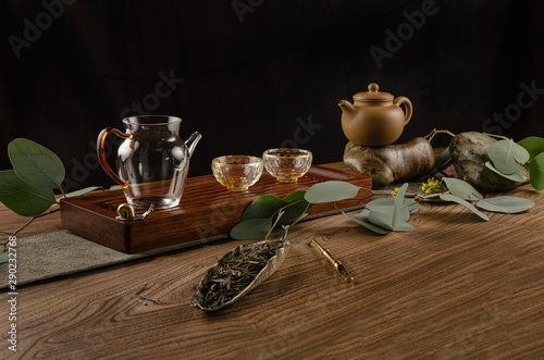 tea table with instruments teapots cups and tea Shen Puer