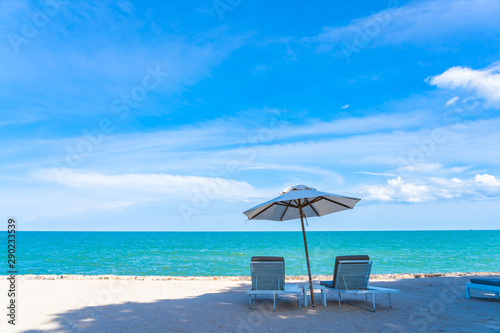 Beautiful umbrella and chair around beach sea ocean with blue sky for travel © siraphol