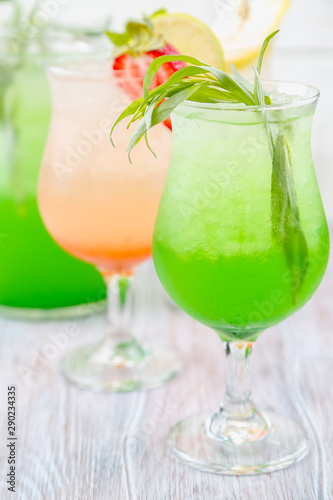 A variety of soft drinks. Assortment of soft drinks. Tarragon lemonade  Strawberry lemonade  Pear lemonade. Lemonade on a light background.