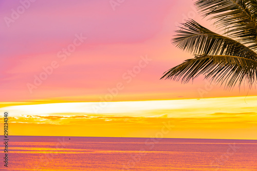 Fototapeta Naklejka Na Ścianę i Meble -  Beautiful sea ocean beach with palm tree at sunrise time for holiday