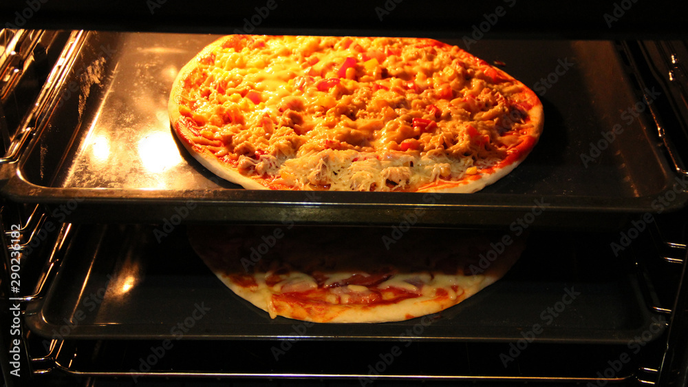 Cook preparing delicious pizza in oven. Cooking fast food in restaurant