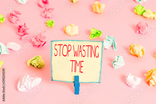 Text sign showing Stop Wasting Time. Business photo text advising demonstrating or group start planning and use it Colored crumpled papers empty reminder pink floor background clothespin