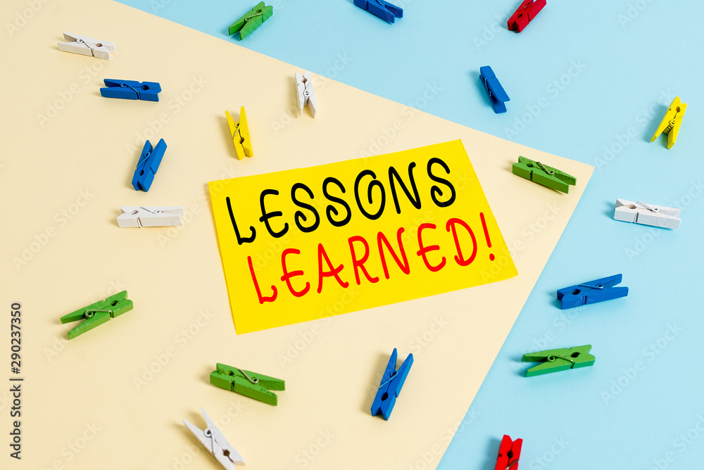 Text sign showing Lessons Learned. Business photo text experiences distilled project that should actively taken Colored clothespin paper empty reminder yellow blue floor background office
