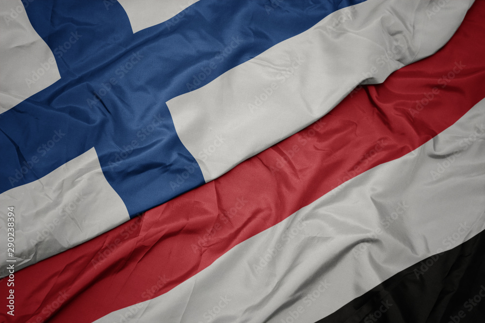 waving colorful flag of yemen and national flag of finland.