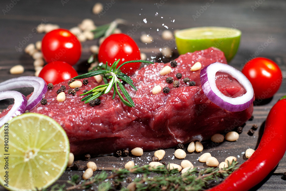 Juicy piece of meat sprinkled with salt with lime and spices tomatoes