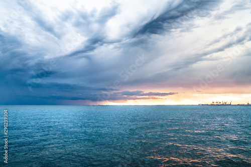 Panoramic view of sea and gray sky at dusk.