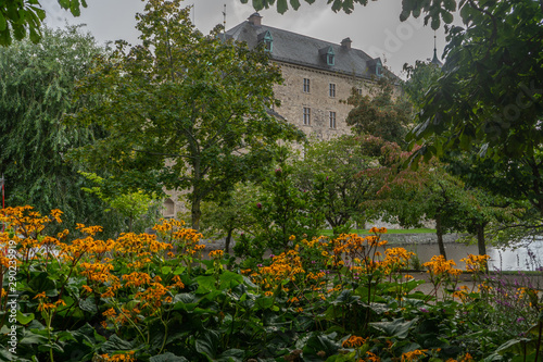 Fragment of Orebro castle with flowers and trees. Castle view from park side. Travel photo, background or illustration.