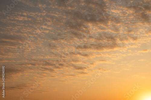 Yellow-orange clouds in the sky during sunrise