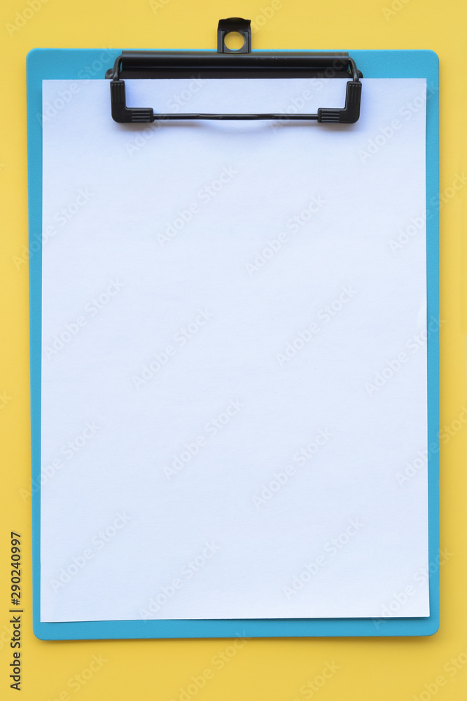 close up of empty paper on yellow background close up of empty paper on yellow background