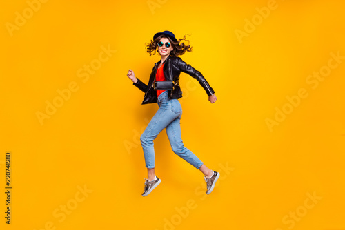 Full body profile side photo of cheerful dreamy jum run enjoy soring weekends wear good look denim jeans isolated over yellow bright color background