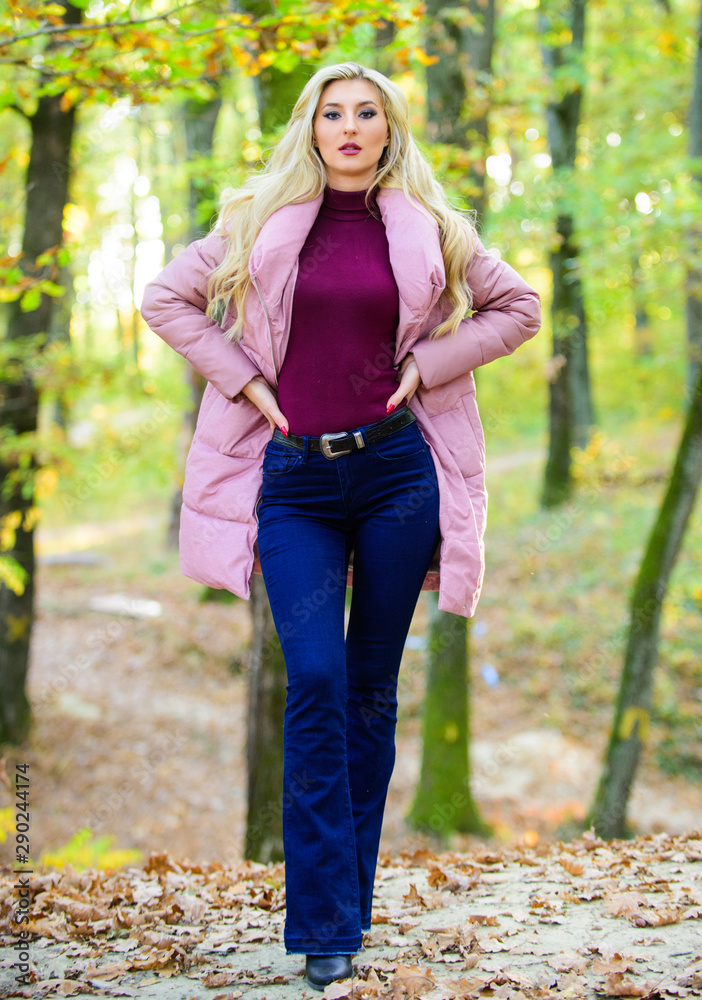 How to repair bleached hair fast and safely. Autumn hair care is important so as to avoid dry frizzy hair. Girl fashionable blonde walk in autumn park. Autumn hair care concept. Cold blonde concept