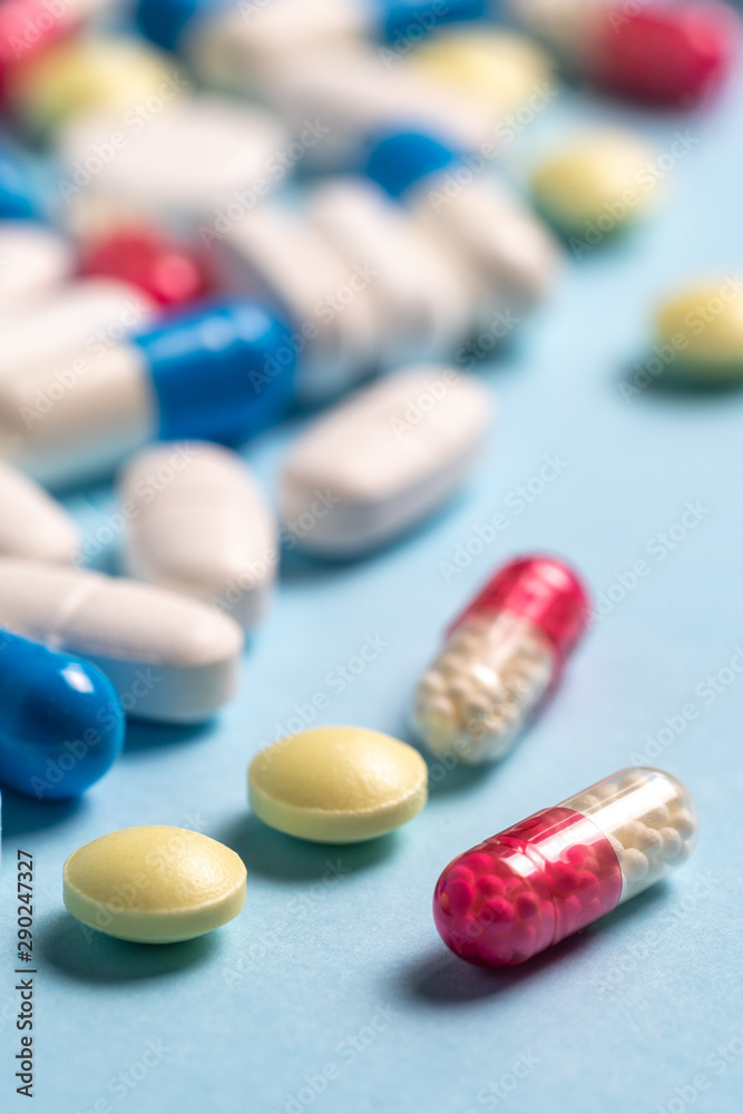 Studio shot of medical pills on blue background - obrazy, fototapety, plakaty 