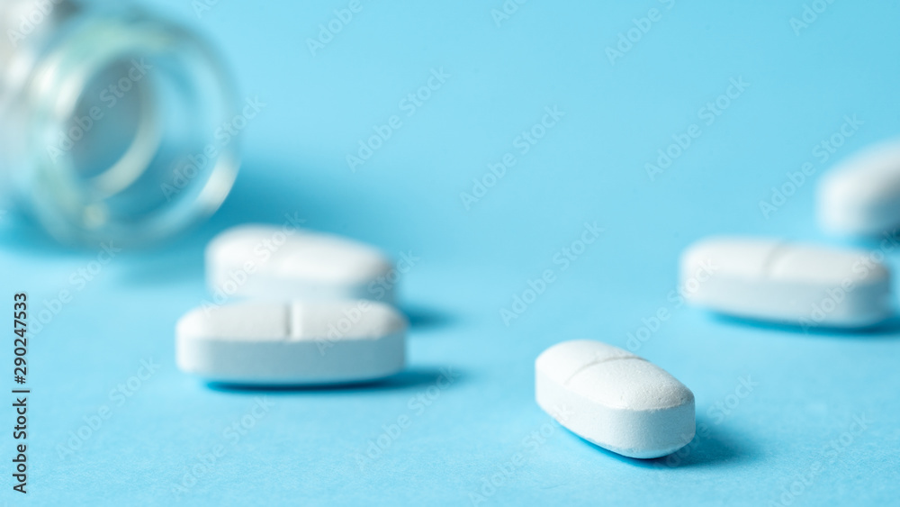 Studio shot of medical pills on blue background Studio shot of medical pills on blue background
