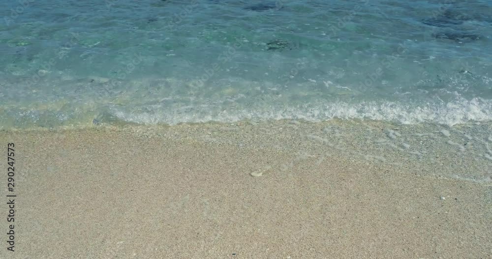 Emerald green water. Beautiful background transparent surface wave, sand on clean beach. Royalty high-quality free stock photo image of clean surface seawater, waves on the beach with sand in sunshine Emerald green water. Beautiful background transparent surface wave, sand on clean beach. Royalty high-quality free stock photo image of clean surface seawater, waves on the beach with sand in sunshine