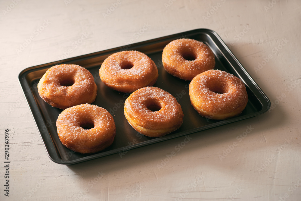 Donuts with sugar on a tray in a bar Donuts with sugar on a tray in a bar