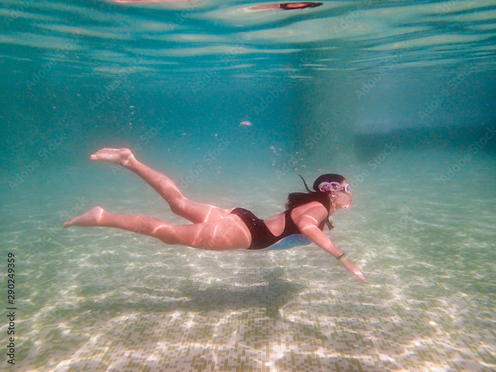 Girl snorkeling in a green swimming pool underwater photography