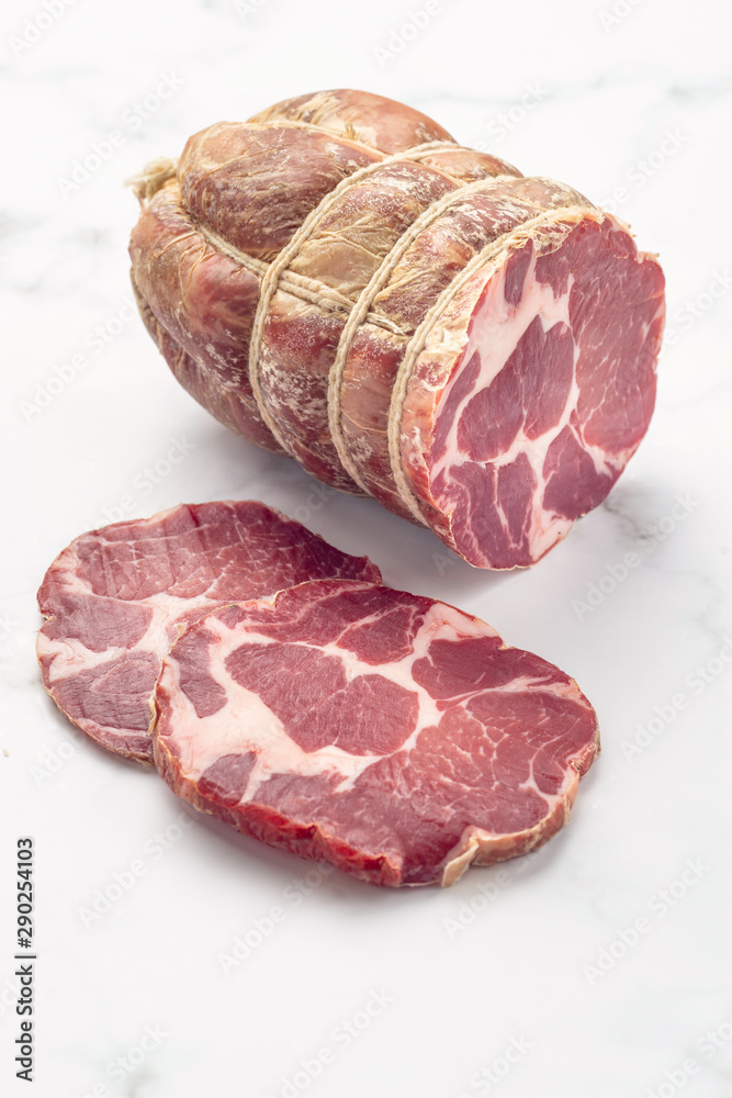 Close up of italian pancetta bacon on white stone