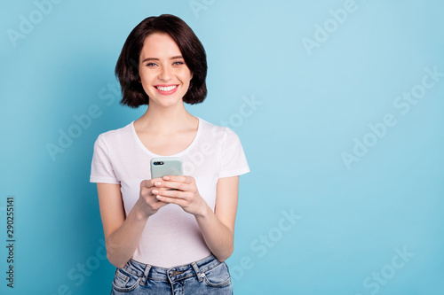 Portrait of her she nice attractive lovely cheerful cheery glad girl using 5g app fast speed internet online media smm isolated on bright vivid shine vibrant blue turquoise color background photo