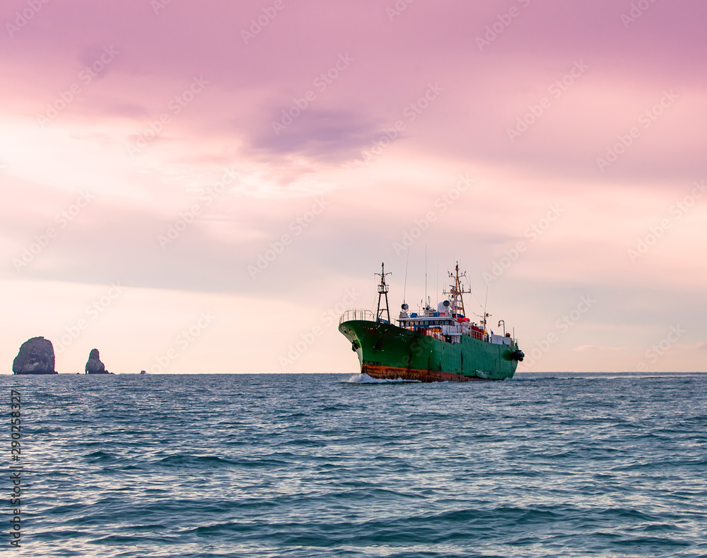 The tugboat in the Pacific ocean near the Kamchatka Peninsula The tugboat in the Pacific ocean near the Kamchatka Peninsula
