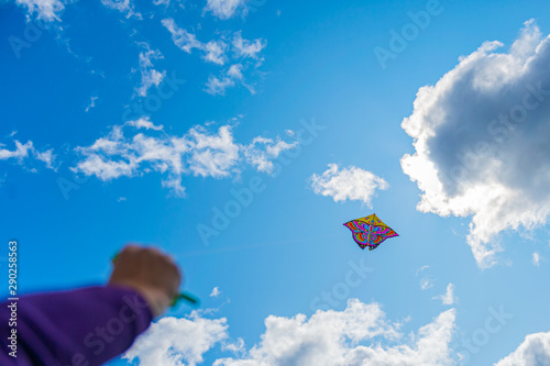 womans handing the rope while playing kite in the sky, enjoy lifestyle in freedom.