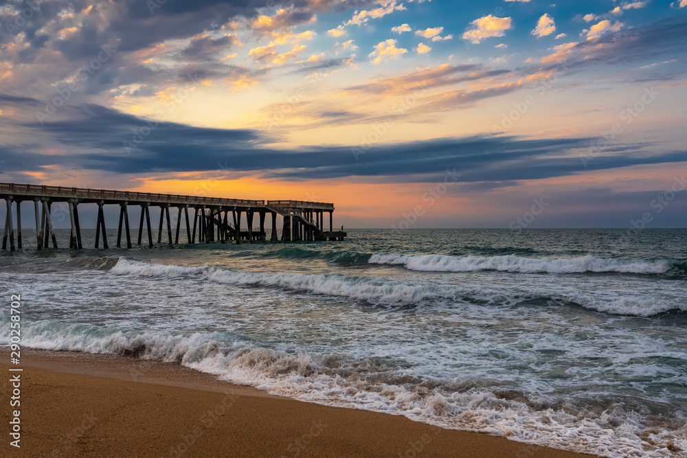 Pier at sunset, wavy beautiful sea Pier at sunset, wavy beautiful sea