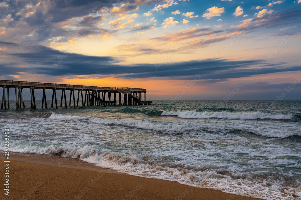 Pier at sunset, wavy beautiful sea