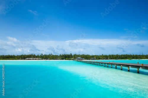 tropical Maldives island with white sandy beach and sea