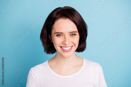 Close-up portrait of her she nice attractive lovely charming cute cheerful cheery girl isolated over bright vivid shine vibrant blue turquoise color background
