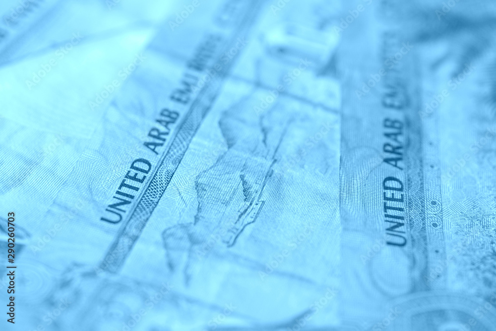 United Arab Emirates banknotes close up blue color toned United Arab Emirates banknotes close up blue color toned