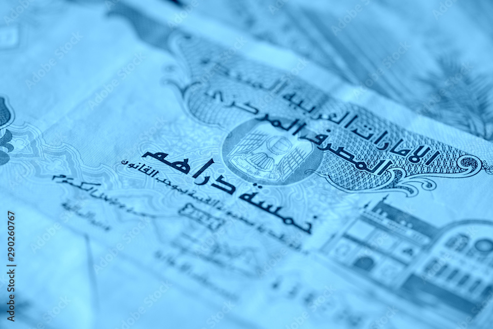 United Arab Emirates banknotes close up blue color toned United Arab Emirates banknotes close up blue color toned
