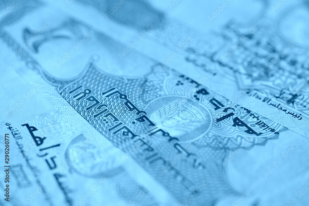United Arab Emirates banknotes close up blue color toned United Arab Emirates banknotes close up blue color toned