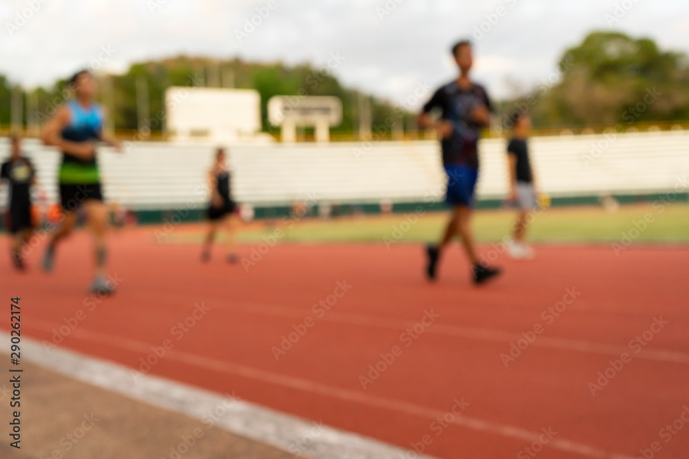 Out of focus runners  outdoors people training in a public sport complex area, healthy lifestyle and sport concepts