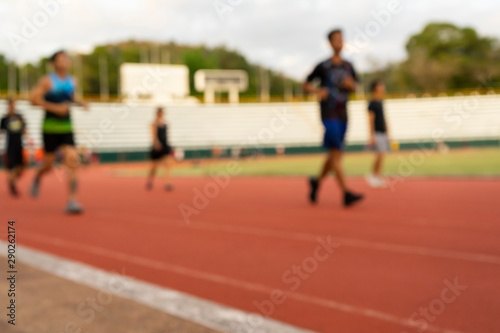 Out of focus runners outdoors people training in a public sport complex area, healthy lifestyle and sport concepts
