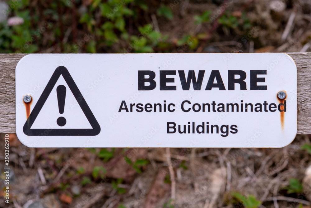 Arsenic warning sign on a gate