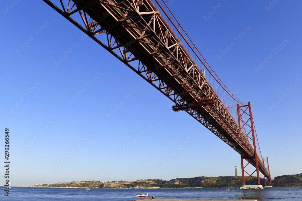 The April 25 Bridge links central Lisbon with the south bank of the Tagus River, the monument of Cristo Rei overlooks the river from a towering pedestal on the south bank, Portugal