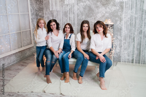 Company beautiful girls celebrating christmas, new year. Girls in the New Year's interior room