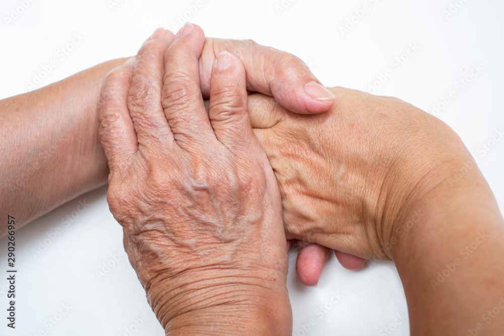 Fototapeta premium hand in hand, Mother holding hand of her daughter on white background ,Asian Body language, Love together concept