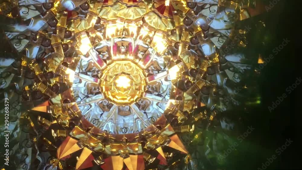 Abstract background, real video shooting done with kaleidoscope. Main colors: golden, green, red, orange, azure. Asymmetrical. 	