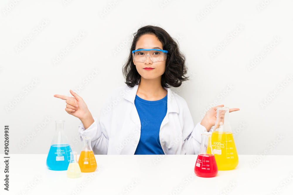 Young scientific asian girl pointing to the laterals having doubts