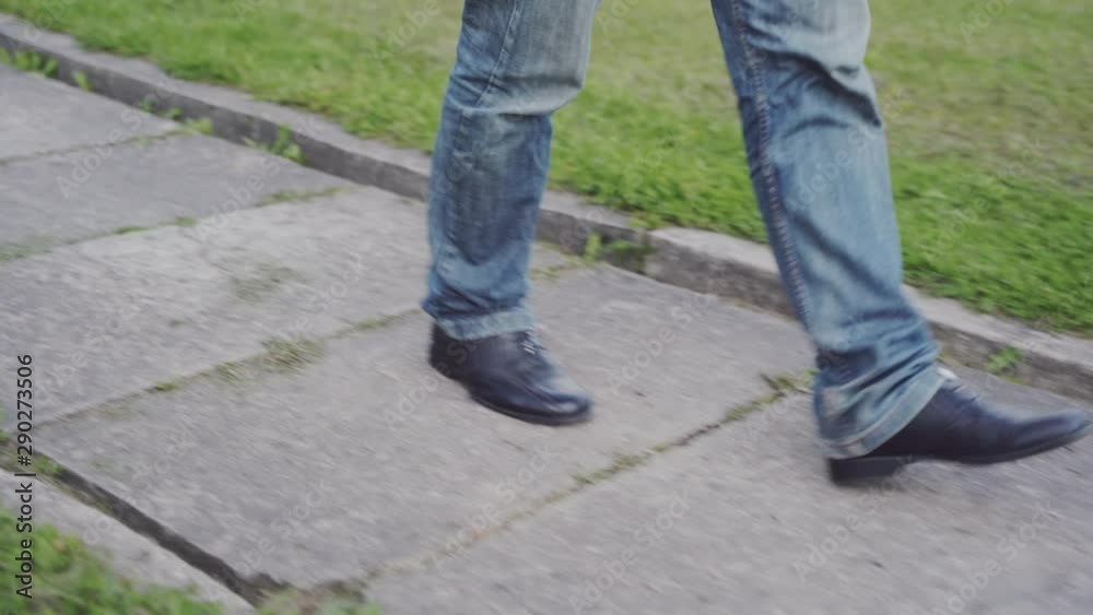 Accidentally stepping into shit on the pavement - after - Man is cleaning his shoe from poo he stepped into. Accidentally stepping into shit on the pavement - after - Man is cleaning his shoe from poo he stepped into.